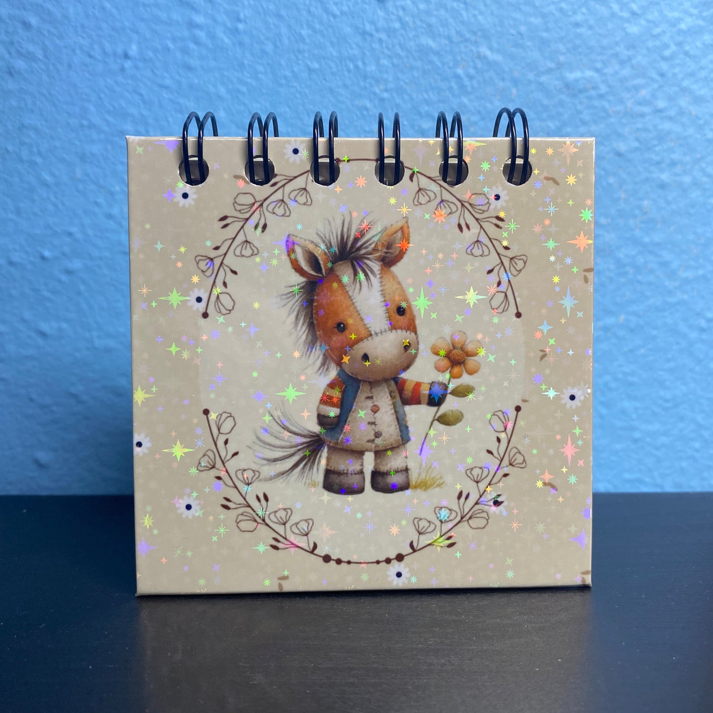 Small notebook with a horse illustration on a blue and black background