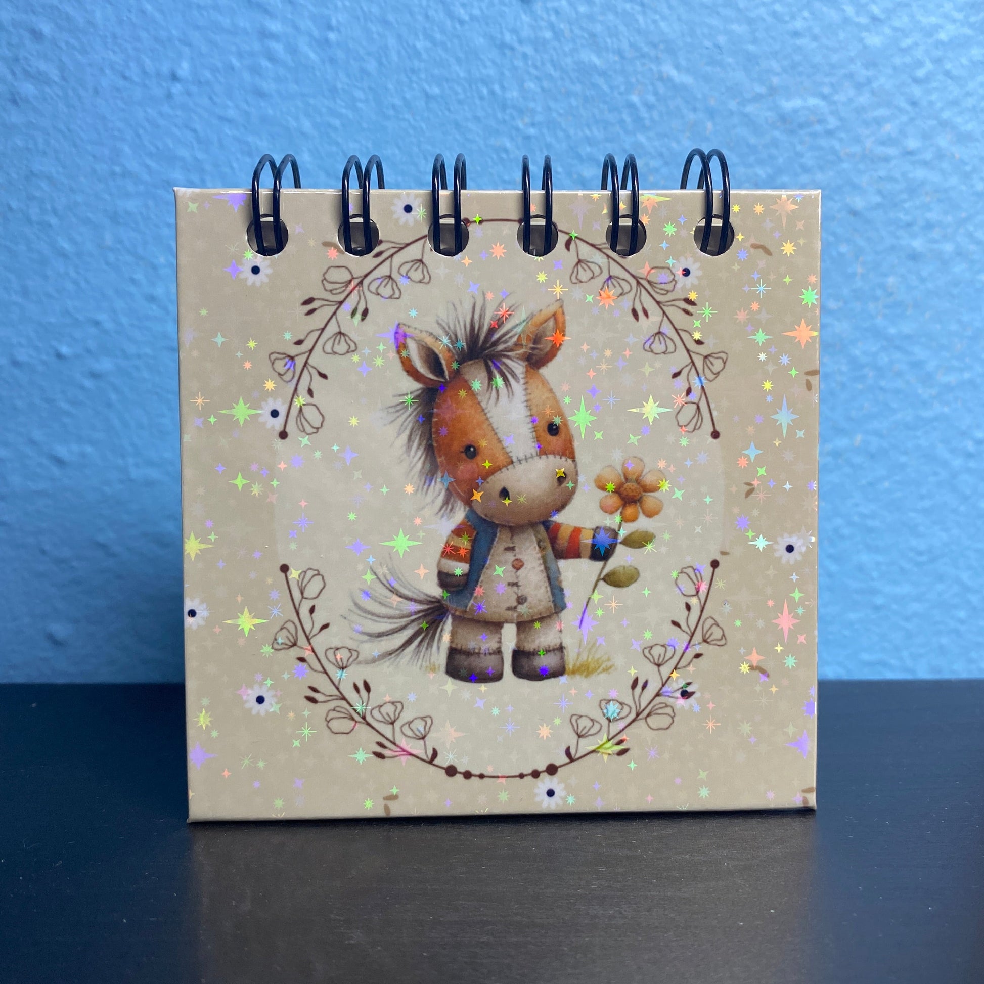 Small notebook with a horse illustration on a blue and black background