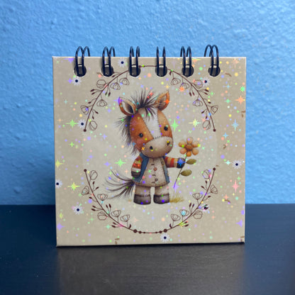 Small notebook with a horse illustration on a blue and black background