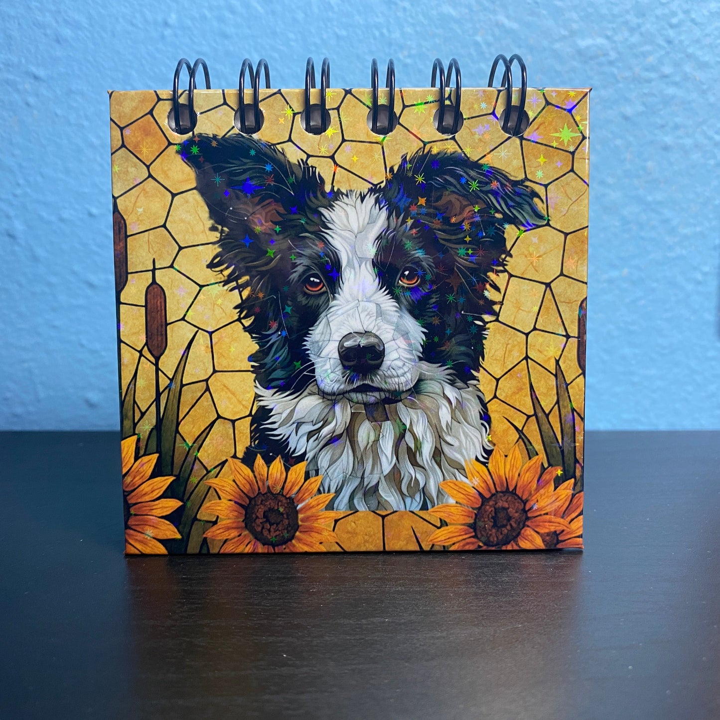 Small notebook with a dog illustration on a yellow background with sunflowers